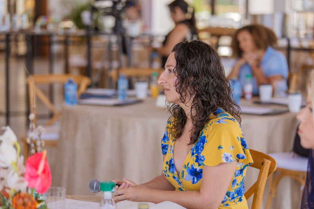 Retreat attendee listening at a table during a session